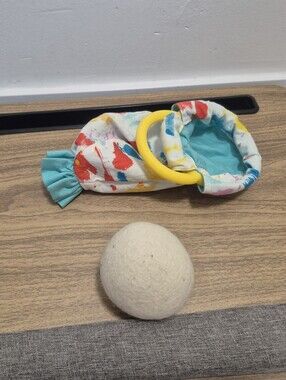 Lovevery Organic Cotton Sensory Pouch with a yellow ring And Ball